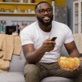 man-watching-tv-eating-chips