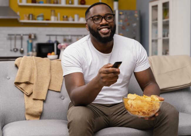 man-watching-tv-eating-chips
